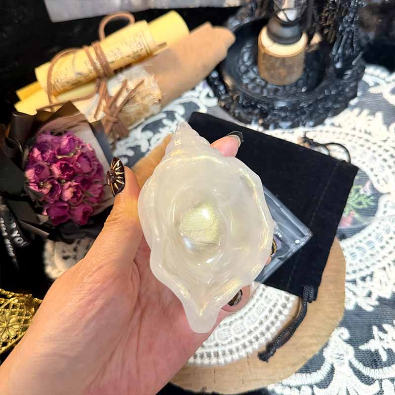 Handmade decor setup featuring seashell jewelry dish and raw crystals