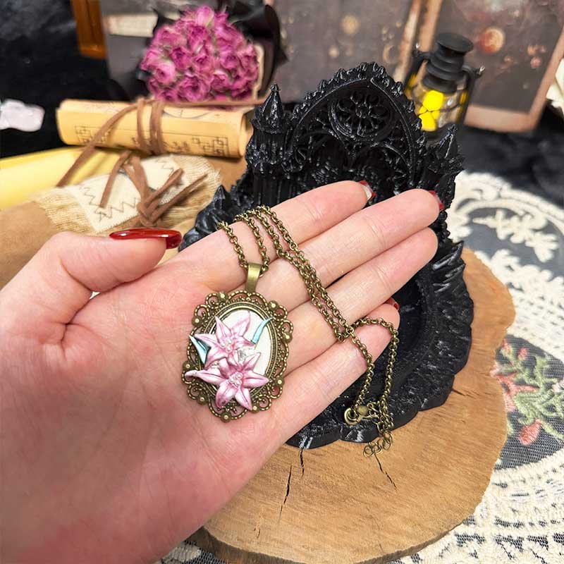 Pink lily flower cameo pendant on antique bronze chain close-up detail
