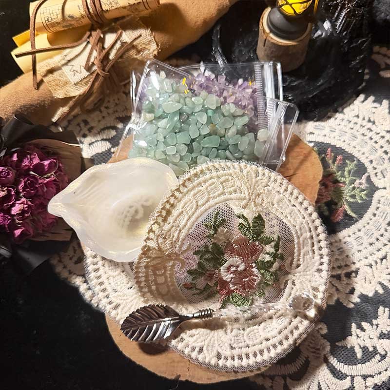 Handmade jewelry care kit featuring a seashell bowl, vintage spoon, lace doilies, and raw crystals