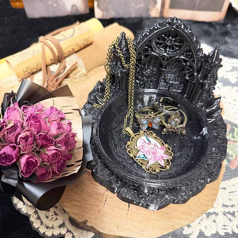 Black gothic vanity tray detail showing pointed arch cathedral silhouette